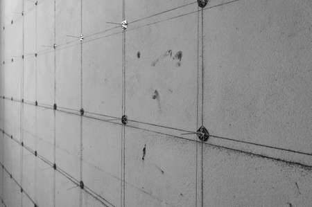 concrete wall with pin for acoustic wall installation, industry construction concept background, black and white toneの写真素材