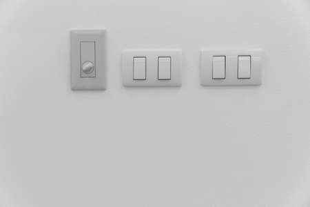 lighting switch and dimmer switch on wall with black and white toneの写真素材