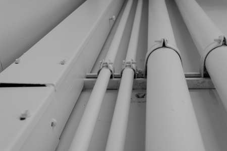 electric pipeline on concrete wall, industry construction concept backgroundの写真素材