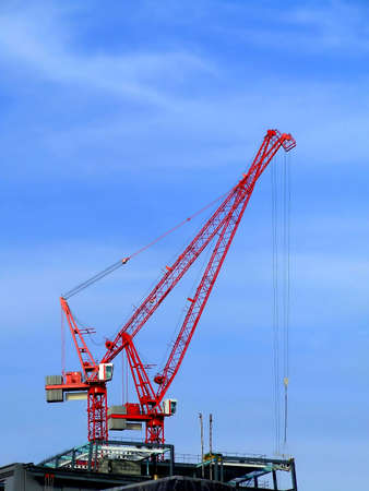 Red crane on a construction siteの写真素材