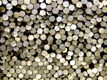 Pile of metal bars with a hexagon shape at the endの写真素材