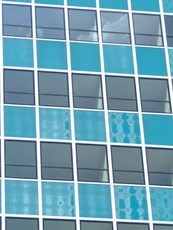 Glass wall of a skyscraper with sun reflection