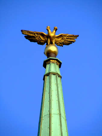 Statue of an eagle on a sharp point architectural buildingの写真素材