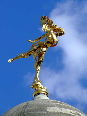 Gold woman statue in Roman style with sky in the backgroundの写真素材
