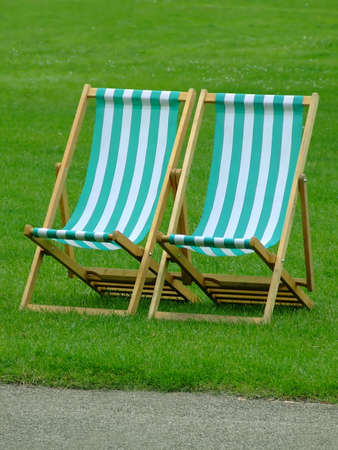 Pair of beach chairs on grassの写真素材