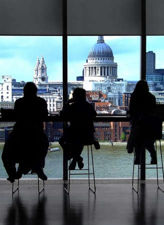 Silhouette of people in cafe with viewの写真素材