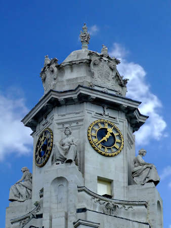 Stone tower with gold clocksの写真素材