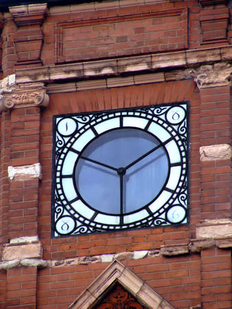 Malleable iron window on a red brick wall