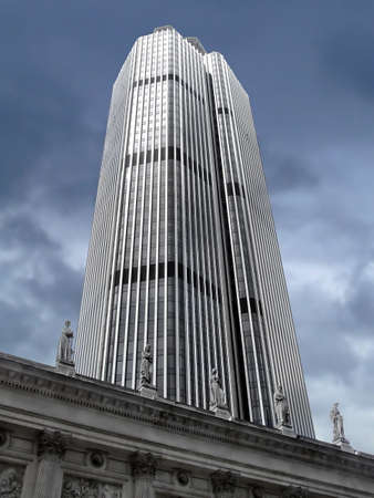 New silver skyscraper behind ancient building with statues