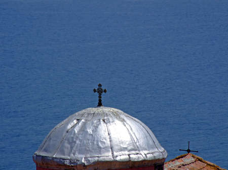Catholic church roof on a small island in the seaの写真素材