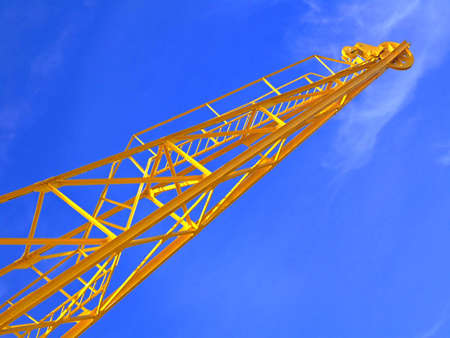 Bright yellow crane with blue sky in the background