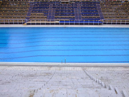 Trembling surface of an sports competition size swimming pool in empty sport arenaの写真素材