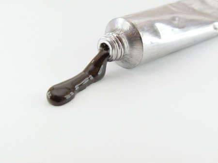 Black art paint in silver container isolated on a whiteの写真素材