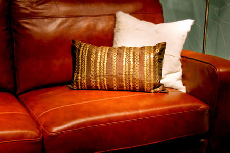 Real brown leather sofa with pair pillowsの写真素材