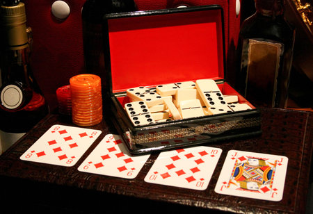 Box of dominoes and playing cards on the leather mateのeditorial素材