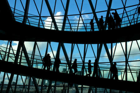 Silhouettes of people in front of big window