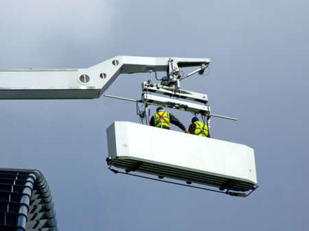 Two maintenance workers in the cabin of craneの写真素材
