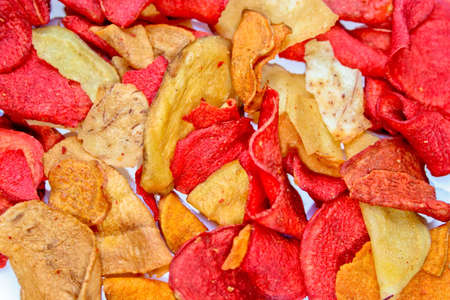 Red and yellow potato chips close upの写真素材