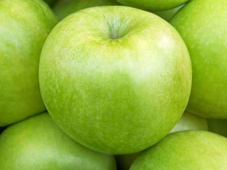 A bunch of green apples on the marketの写真素材