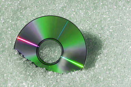 Green DVD disk with plastic granulate materialの写真素材