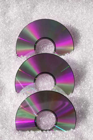 Three pink CDs with plastic granulate materialの写真素材