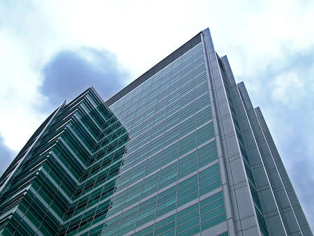 Big sharp skyscraper tower with green glass 