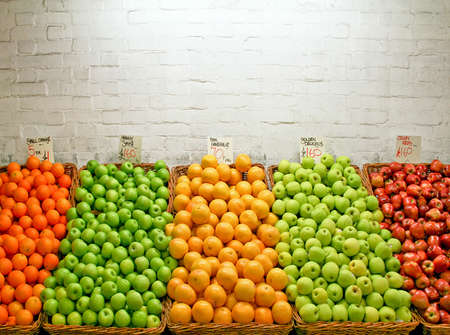 A bunch of various apples on the stallの写真素材