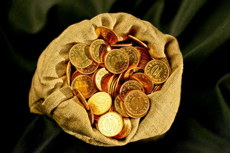 Bunch of golden coins in money sackの写真素材