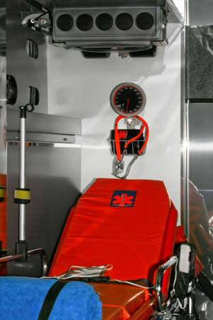 Inside view of ambulance vehicle with bed and equipment