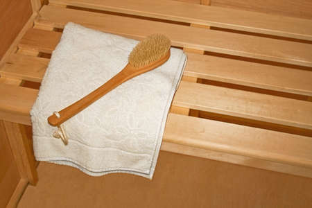 Inside sauna towel and brush on the benchの写真素材