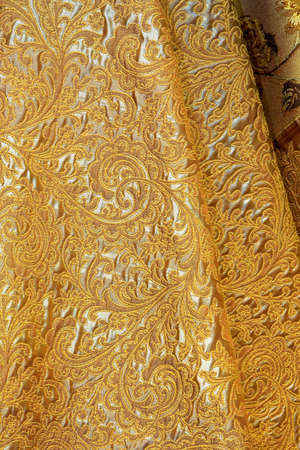 Luxurious golden linen material with floral designの写真素材