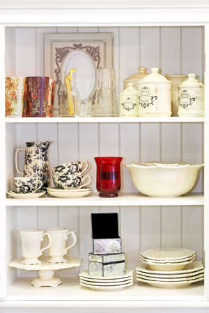 Vintage style white cupboard with kitchenware and china 