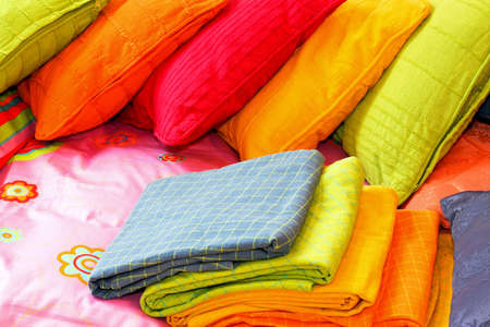 Bunch of colorful pillows and blankets for bedの写真素材