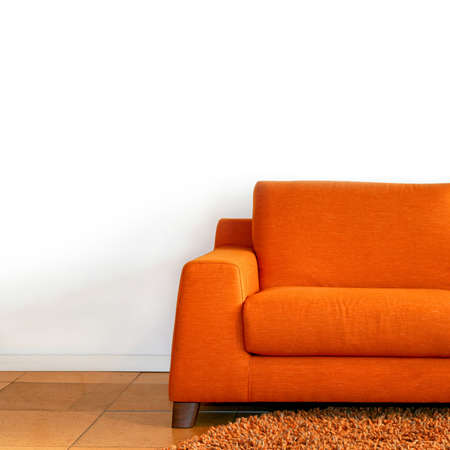 Comfort orange textile sofa in living room の写真素材