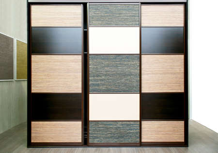 Big brown wood wardrobe closet in bedroomの写真素材