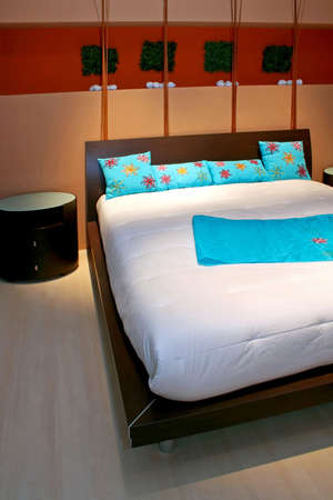 Modern bedroom with big bed and blue details