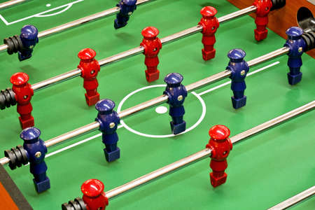 Tabletop foosball game with red and blue figuresの写真素材
