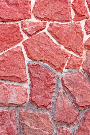 Wall made from natural rough red stones の写真素材