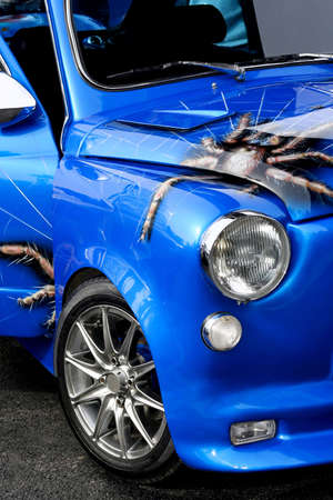 Small vintage car in glossy blue paint