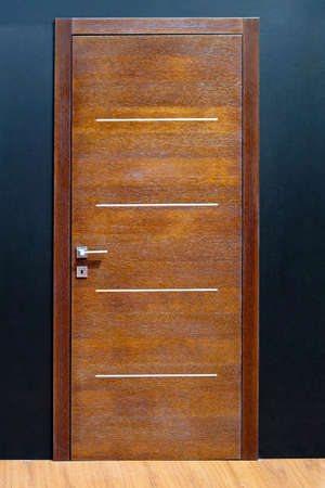 Closed brown wood door in home interior