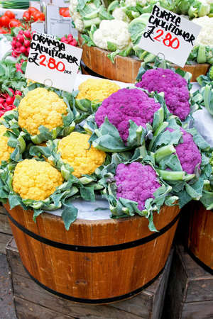 Orange and purple cauliflowers in wooden bucketsの写真素材