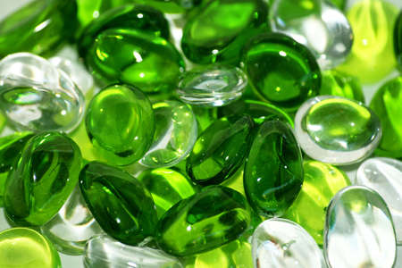 Bunch of green and transparent glass pebbles and stonesの写真素材