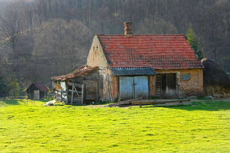 Old village stall and green grass fieldの写真素材