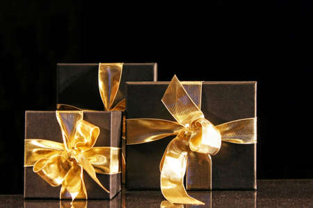 Close up shot of Christmas gifts with golden bowの写真素材