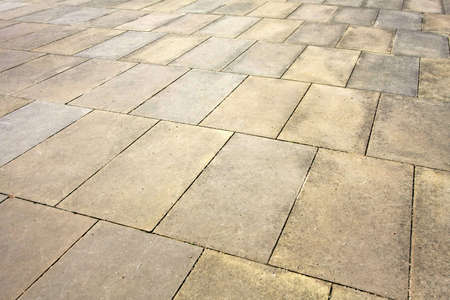 Angle shot of sidewalk pavement plates textureの写真素材