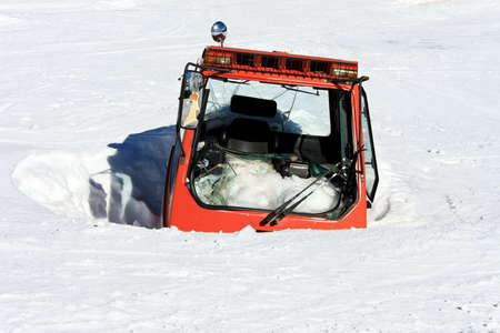 Red cabin under avalanche of snow at mountainの写真素材