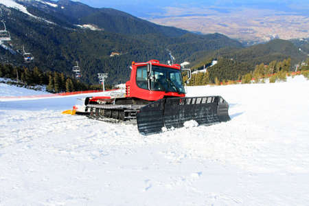Big snow groomer equipment in snowy mountainの写真素材