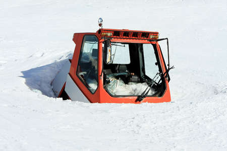 Red cabin under avalanche of snow at mountainの写真素材