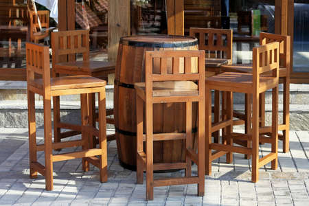 Wooden chairs and barrel in front of pubの写真素材