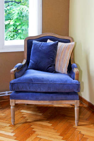 Blue plush arm chair with two pillows の写真素材